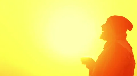 The young man drinks tea at dawn. Bearded man at sunrise with a cup of tea. Stock Footage 58576975
