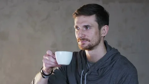Young Man Drinks Tea From a White Cup Stock Footage 69170810