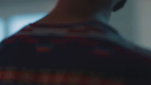 A young man drinks water and stands at the window in the office. Slow motion Stock Footage