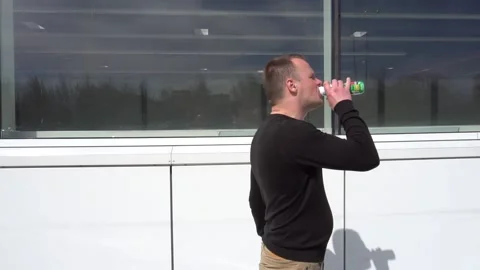 Young man drinks yogurt. Slow motion Video stock 89594810