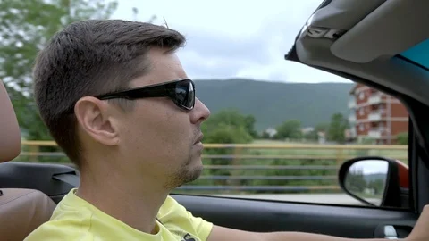 Young man driving a cabriolet Stock Footage 92937159