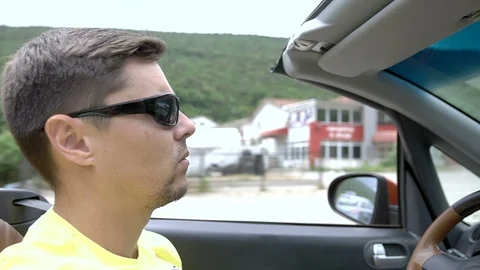 Young man driving a cabriolet Stock Footage 92937429