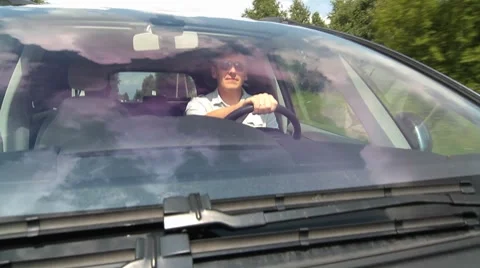 The young man driving a car Stockbeeldmateriaal 7765999