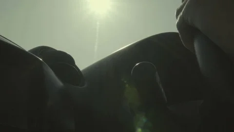 Young man driving car. Hands on steering wheel. Sunny day. Slow motion Stock Footage 84886992