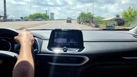 Young man driving a car using map app. Person holds steering wheel and using gps Stock Footage 309561159