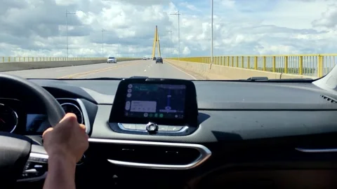 Young man driving a car using map app. Person holds steering wheel and using gps Stock Footage 309561201