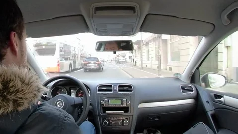 Young man driving a car, view from back seat through windshield Stock Footage 103792391
