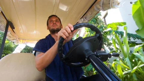 Young man driving a golf car. Stock Footage 101770385