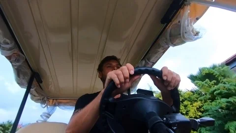 Young man driving a golf car. Stock Footage 101828019
