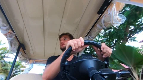 Young man driving a golf car. Stock Footage 101828074