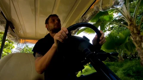 Young man driving a golf car. Stock Footage 101828077