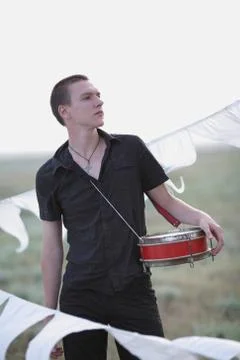 Young man with a drum Stock Photos