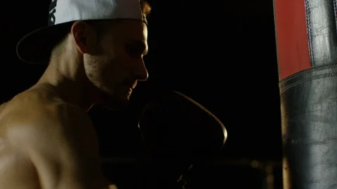 Young Man During The Boxing Training On The Dark Background Hitting The Punching Video stock 112600671