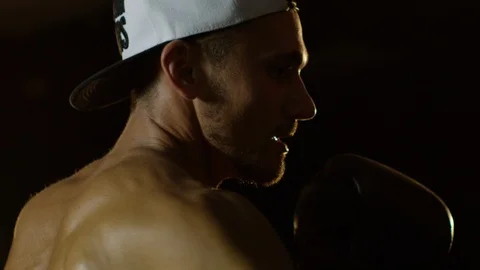 Young Man During The Boxing Training On The Dark Background Hitting The Punching Stock Footage 112601043
