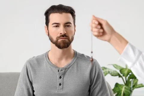 Young man during hypnosis session at psychologist's office Stock Photos