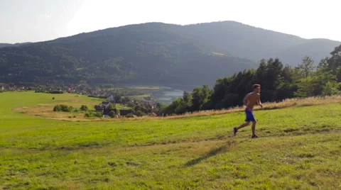 Young man during intense running workout in mountains Stock Footage 55866039