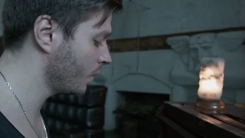 A young man with an easy shield plays the piano and sings. A handsome man with a Stock Footage 75070151