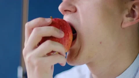 Young man eating apple, close up Stock-Footage 143201259