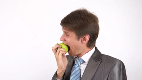 Young man eating an apple Stock Footage 92776959