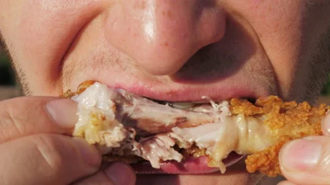 Young man eating fat fried chicken Stock Footage