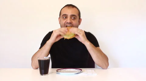 Young man eating a hamburger, time lapse Stock Footage 34405412