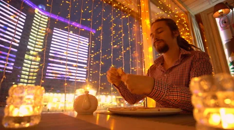 A young man is eating a pizza Stock Footage 65080447
