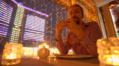 A young man is eating a pizza Stock Footage 65080468