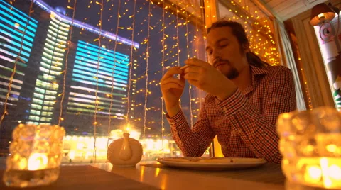 A young man is eating a pizza Stock Footage 65080620