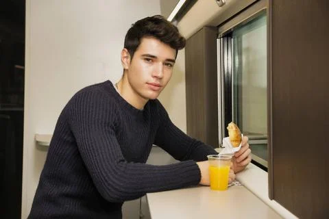  Young man eating refreshments on a train Young man eating refreshments on... Stock Photos