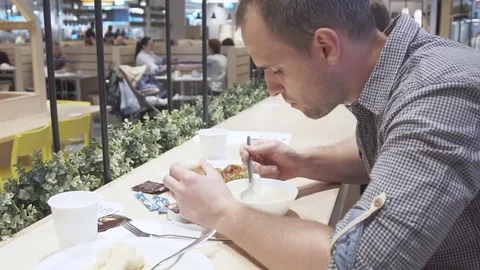 Young man eating in restaurant. Video stock 78982334