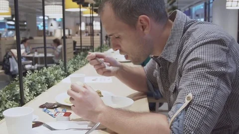 Young man eating in restaurant. Video stock 78982424