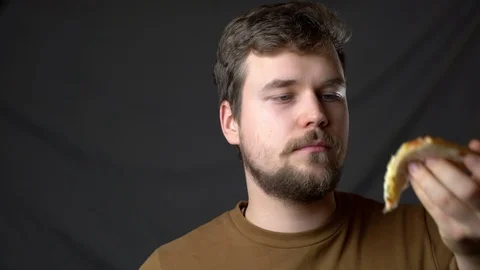 A young man eats cheesy pizza Stock-Footage 124514155