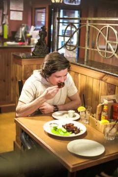Young Man Eats Dinner at Restaurant Stock Photos
