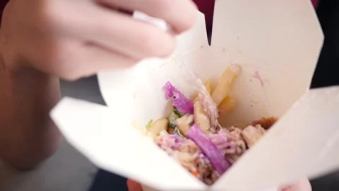 Young Man eats Doner Kebab from a Box at Home Stock Footage 143806286
