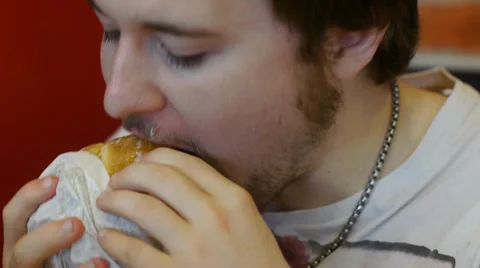Young Man Eats Double Cheeseburger Stock Footage 39840421