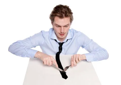 Young man eats his necktie Stock Photos