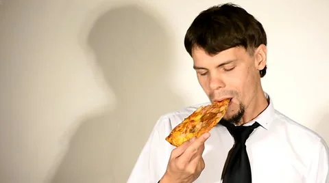 Young man eats pizza and shows thumb up Stock Footage 67982867