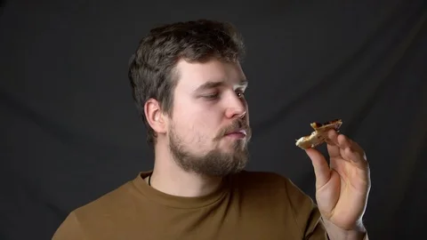 A young man eats pizza and enjoys it Stock-Footage 124514945
