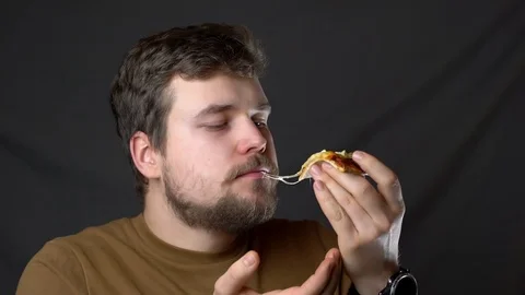 A young man eats pizza with cheese Stock-Footage 124515293