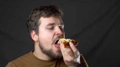 A young man eats pizza cheesy Stock-Footage 124516031
