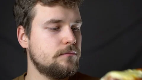 A young man eats pizza close up Stock-Footage 124504028