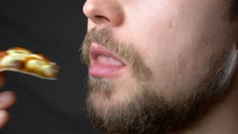 A young man eats pizza slow motion super close up profile Stock-Footage 124504771