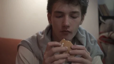 Young man eats a sandwich Stock Footage 127750519