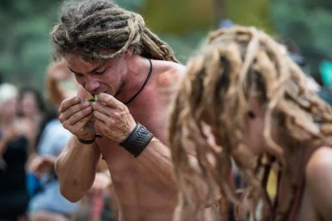 A young man eats a slice of lemon on the main stage of the psytrance Lost Theory Stock Photos
