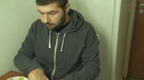 Young Man Eats Some Tortilas Diped In Some Cheese Dip Front Shot Stock-Footage 33660452