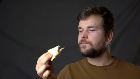 A young man eats very tasty cheesy pizza Stock-Footage 124503705