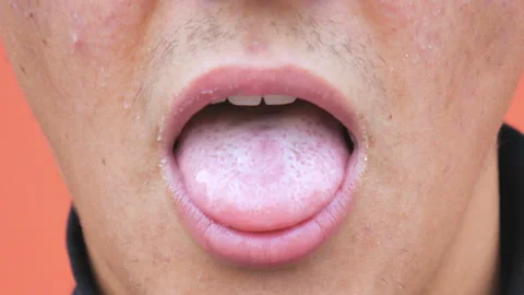 A young man eats yogurt from a spoon. Close up. Stock Footage 97443499