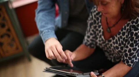 Young Man Educates Mother on Using Tablet Device Stock Footage 53472781