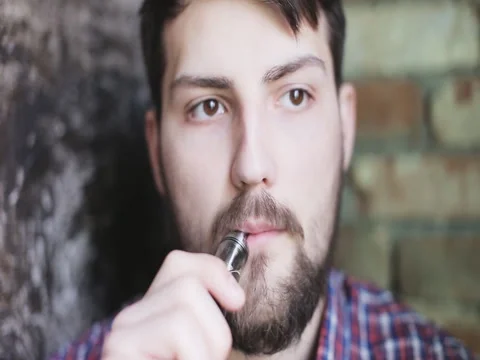 Young man with electronic cigarette Video stock 63483682