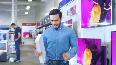 Young Man in Electronics Store Purchased Latest Model of the Tablet Computer Video stock 79744034